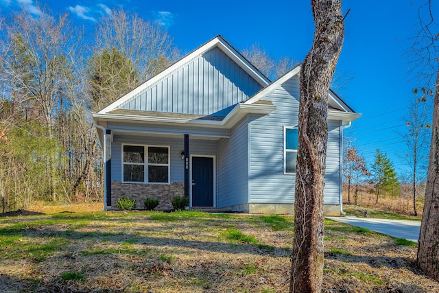 view of front of property featuring board and batten siding and a front yard