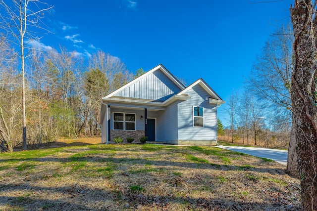 view of front of property with a front lawn and board and batten siding