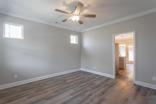 unfurnished room with dark wood finished floors, crown molding, a ceiling fan, and baseboards