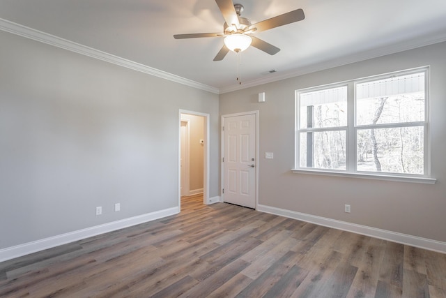 interior space with visible vents, baseboards, ornamental molding, wood finished floors, and a ceiling fan