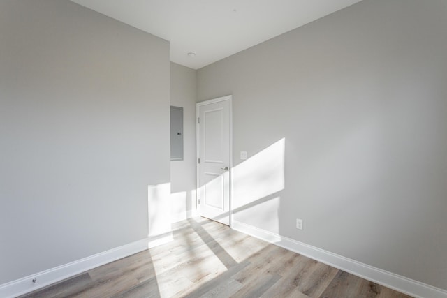 unfurnished room with baseboards and wood finished floors