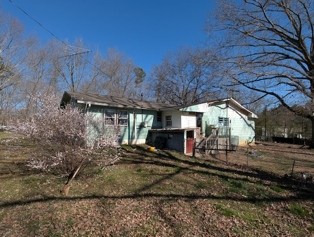 back of house with a yard and fence