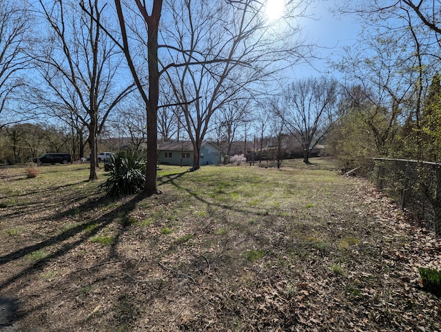 view of yard featuring a rural view and fence