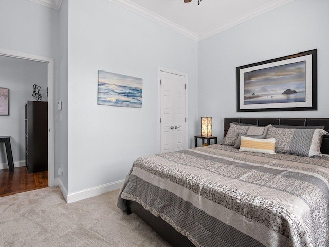 carpeted bedroom featuring baseboards and ornamental molding