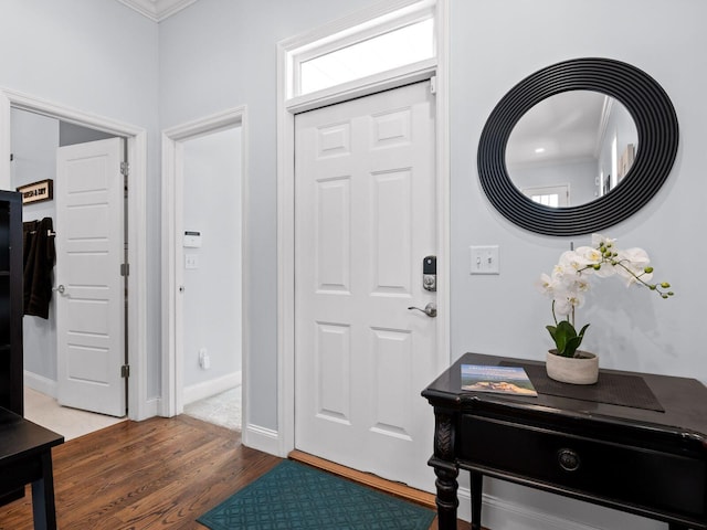 foyer with wood finished floors and baseboards