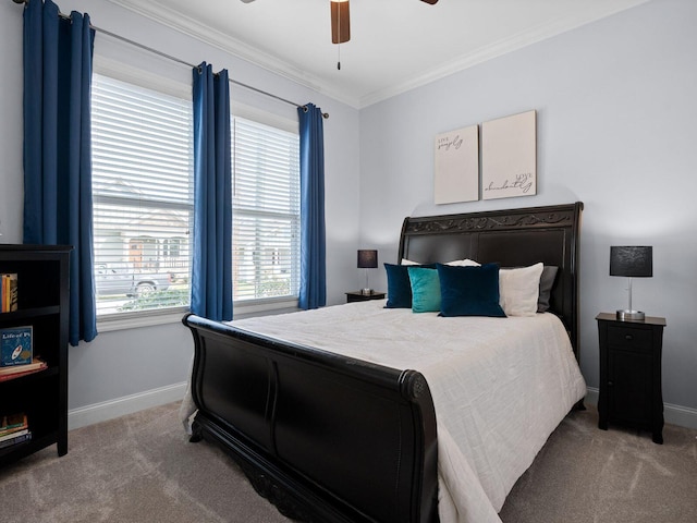 carpeted bedroom with baseboards, ceiling fan, and crown molding