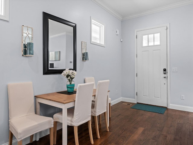 dining room with crown molding, dark wood-style floors, and baseboards