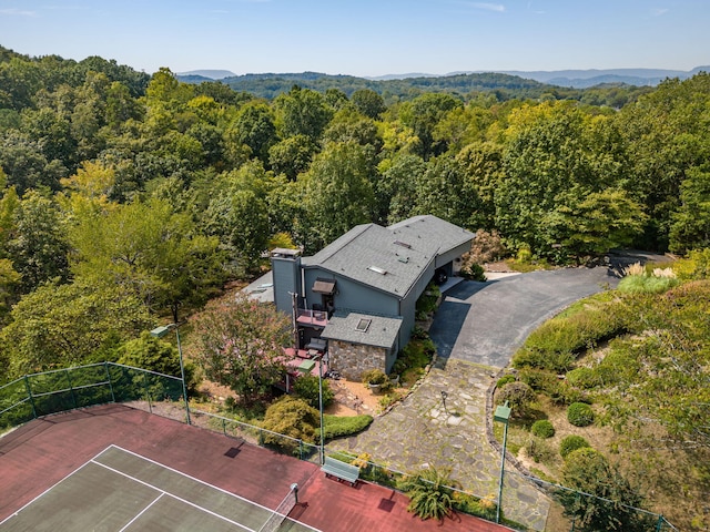 birds eye view of property featuring a mountain view and a wooded view