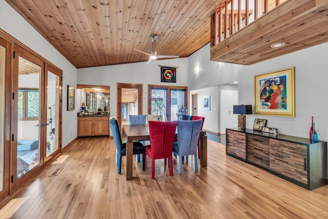 dining space featuring baseboards, vaulted ceiling, french doors, wooden ceiling, and light wood-type flooring