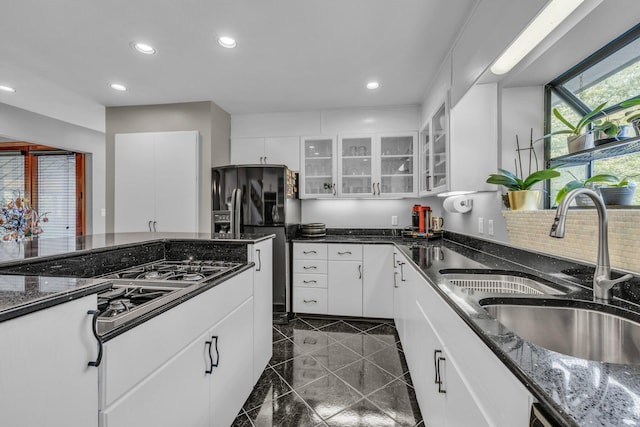 kitchen featuring a sink, glass insert cabinets, black appliances, and white cabinetry