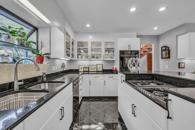 kitchen with recessed lighting, white cabinets, glass insert cabinets, and a sink