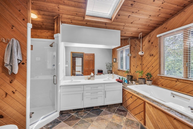 bathroom featuring wood walls, wood ceiling, double vanity, a stall shower, and a sink