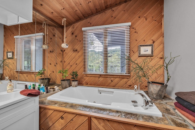 full bathroom featuring wood ceiling, a tub with jets, vanity, and vaulted ceiling