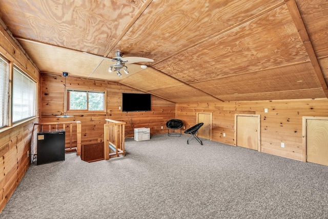 unfurnished office featuring wooden walls, wooden ceiling, lofted ceiling, and carpet floors