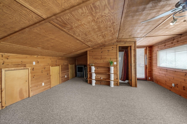 bonus room featuring vaulted ceiling, carpet, wood walls, and wooden ceiling