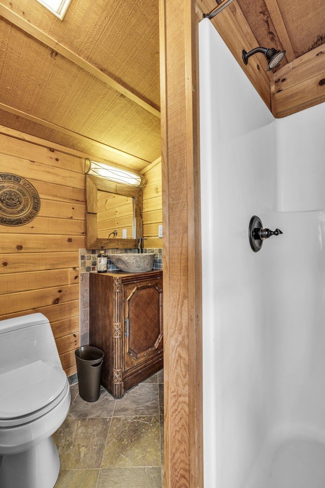 full bath with wooden ceiling, wooden walls, toilet, and walk in shower