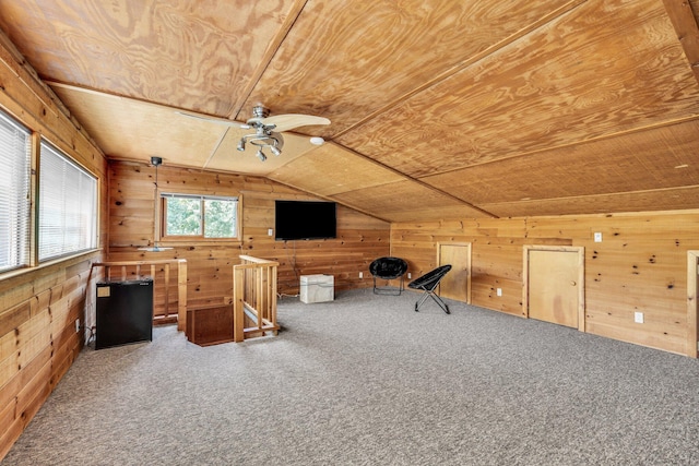 unfurnished office with wooden walls, carpet floors, ceiling fan, vaulted ceiling, and wood ceiling