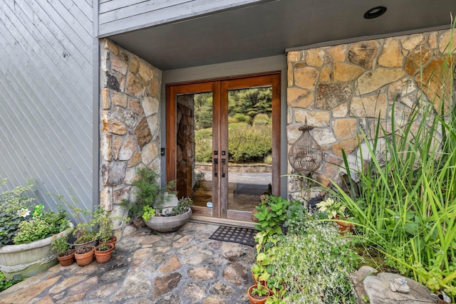 doorway to property with stone siding