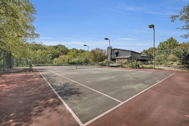 view of tennis court with fence