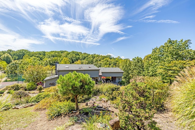 exterior space with a wooded view