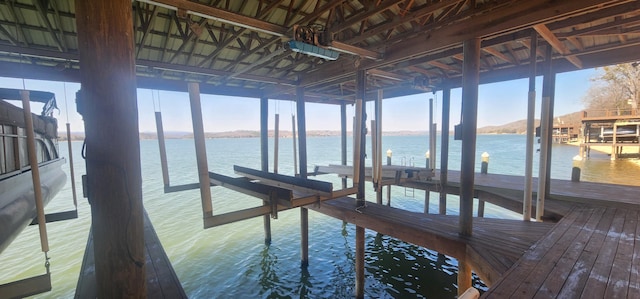 dock area with boat lift and a water view