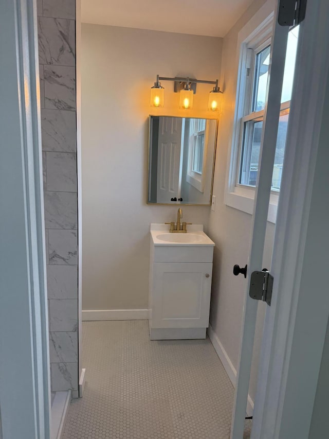 bathroom featuring vanity, baseboards, and tile patterned flooring