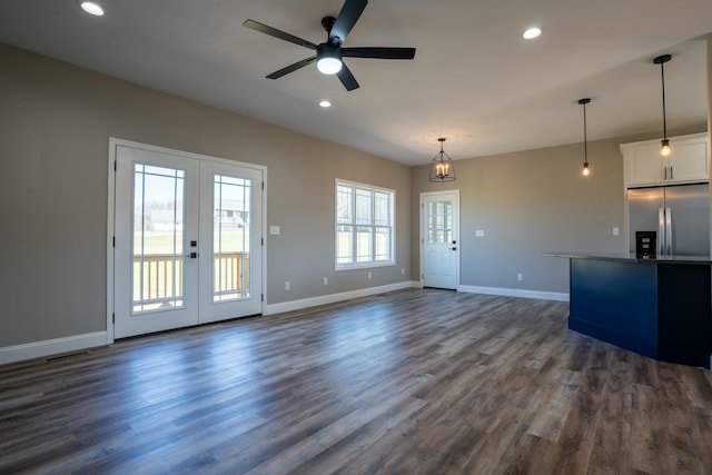 unfurnished living room featuring recessed lighting, baseboards, and dark wood finished floors