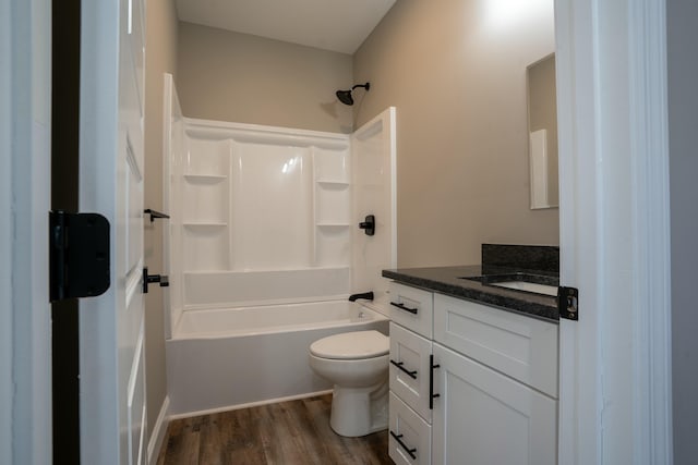 bathroom with toilet, vanity, bathtub / shower combination, and wood finished floors