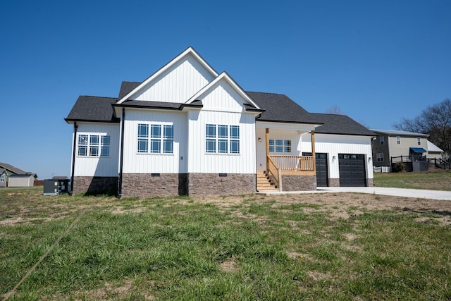 modern inspired farmhouse featuring a front yard, cooling unit, roof with shingles, an attached garage, and concrete driveway