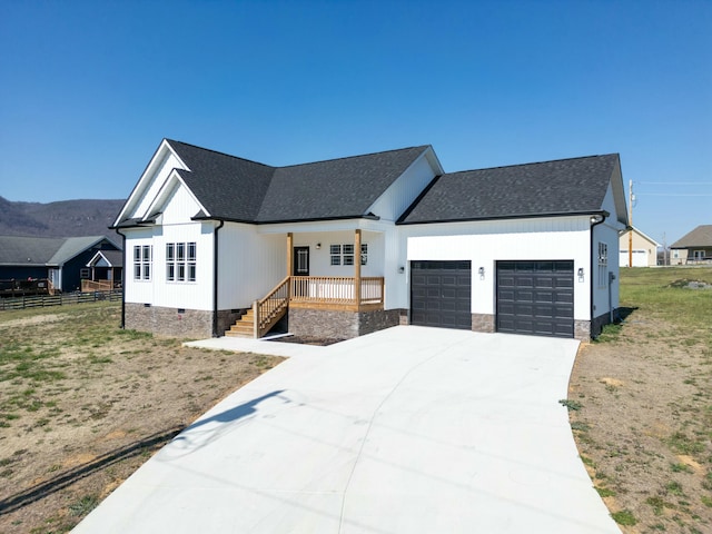 modern farmhouse style home with an attached garage, fence, roof with shingles, and crawl space