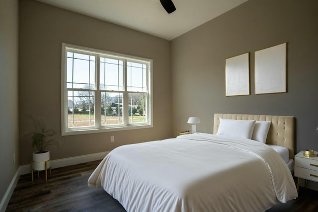 bedroom with wood finished floors, baseboards, and ceiling fan