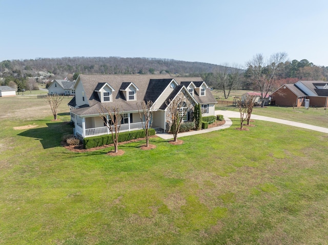 view of front facade with concrete driveway and a front yard