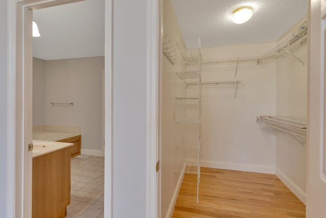 walk in closet featuring light wood-type flooring