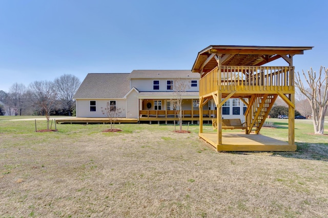 back of property featuring a deck and a yard