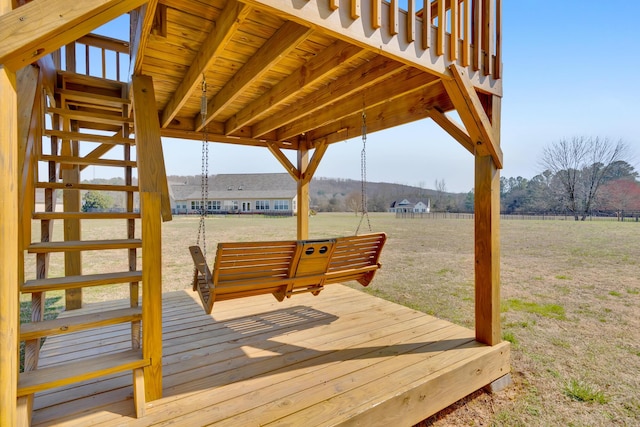 deck featuring a yard and a rural view