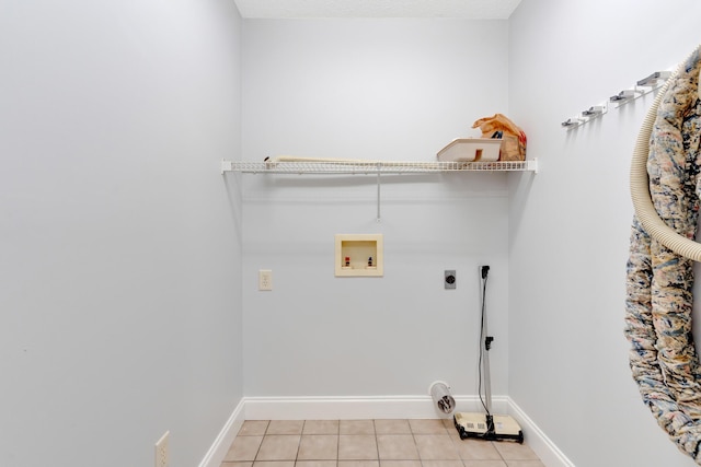 laundry area featuring light tile patterned flooring, baseboards, hookup for an electric dryer, hookup for a washing machine, and laundry area