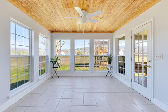 unfurnished sunroom with wooden ceiling and a ceiling fan