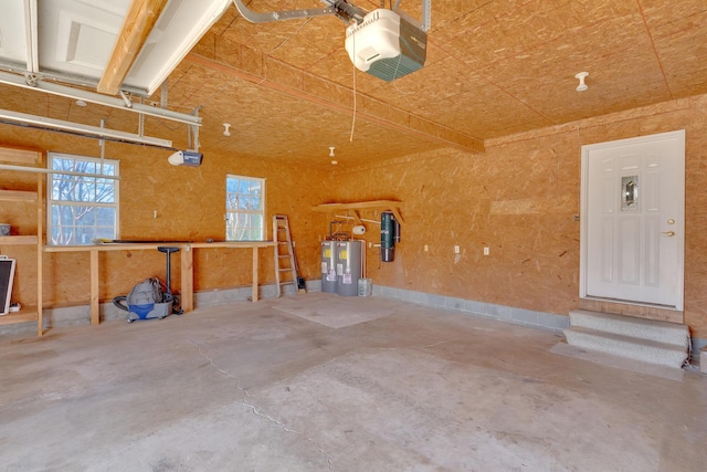 garage featuring a garage door opener and electric water heater