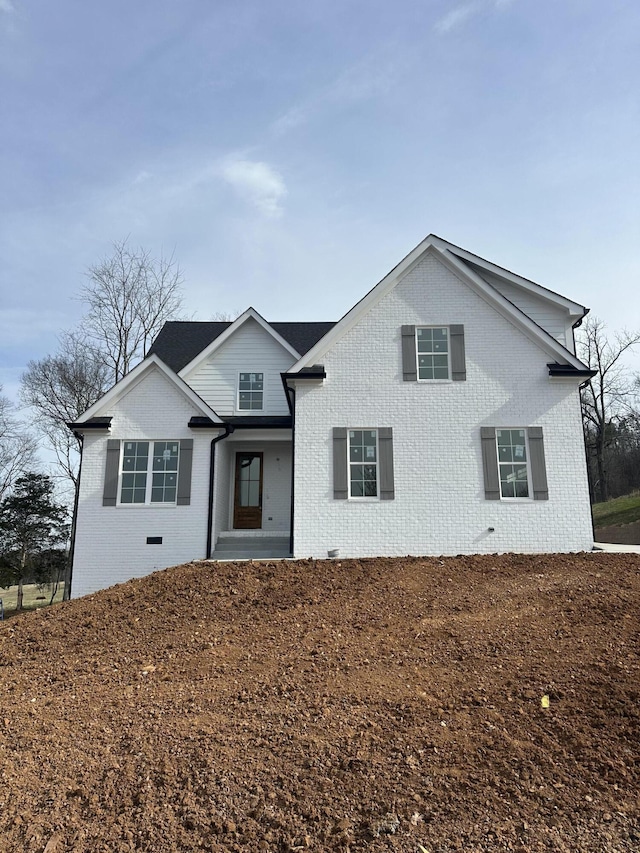 traditional-style house with crawl space and brick siding