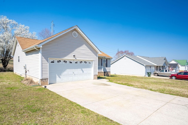 view of side of property with driveway, a lawn, and an attached garage