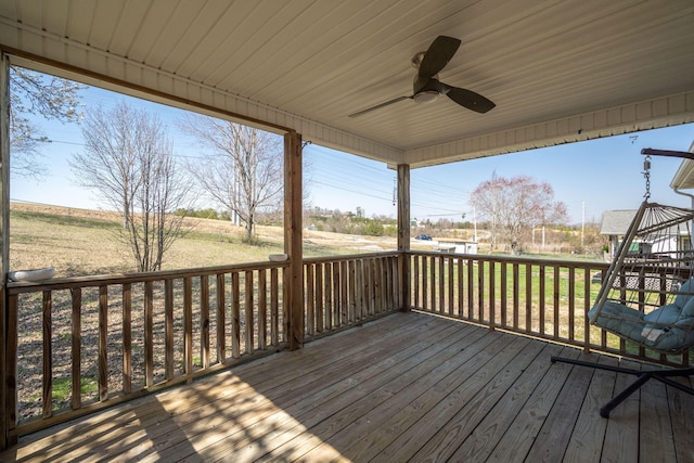 wooden deck with a ceiling fan