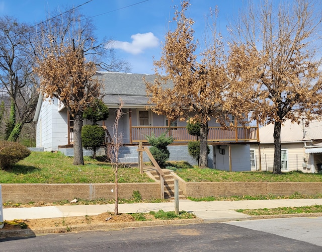 view of front facade with a porch, roof with shingles, and stairway