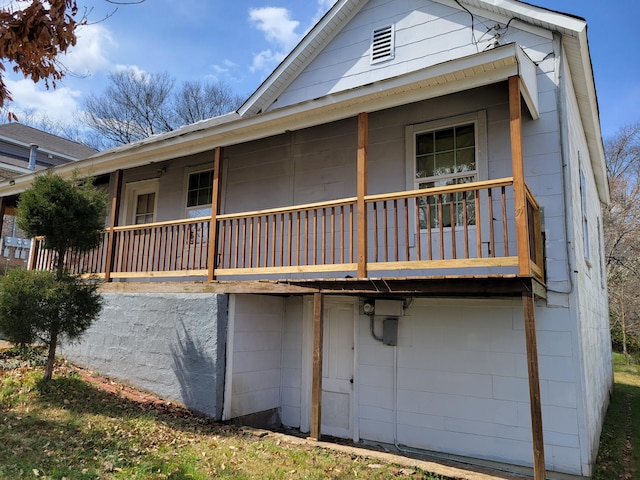 rear view of house featuring a porch