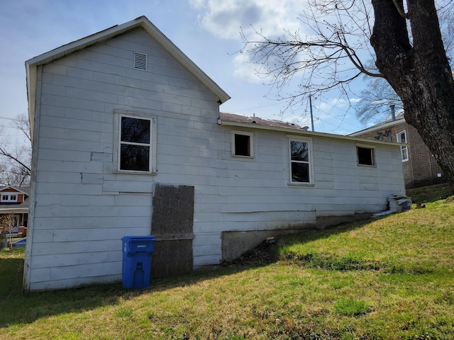 view of property exterior featuring a lawn