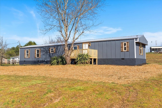 manufactured / mobile home with crawl space, metal roof, a wooden deck, and a front lawn