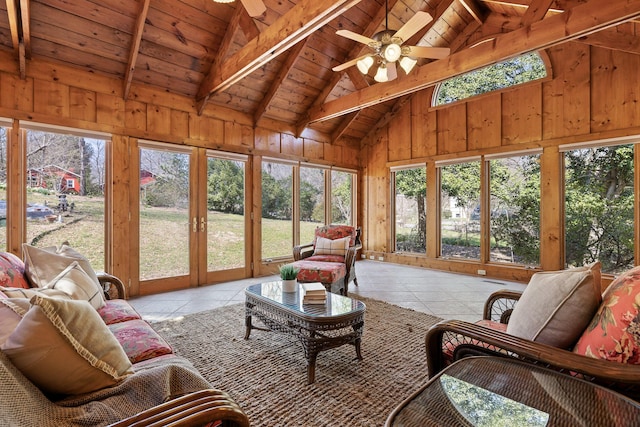 sunroom featuring wood ceiling, lofted ceiling with beams, and a ceiling fan