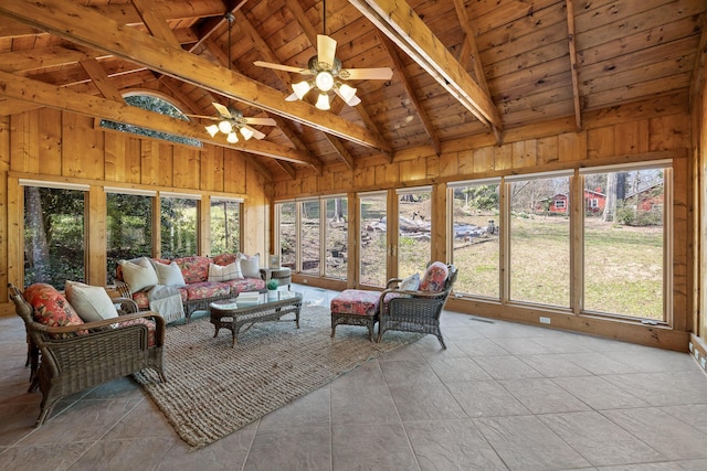 sunroom with ceiling fan, wooden ceiling, and vaulted ceiling with beams