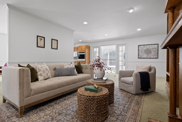 carpeted living area featuring recessed lighting and ornamental molding