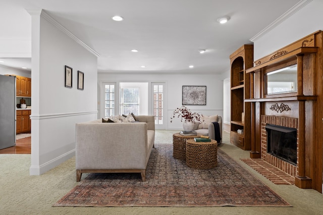 living room featuring recessed lighting, light carpet, a brick fireplace, and crown molding