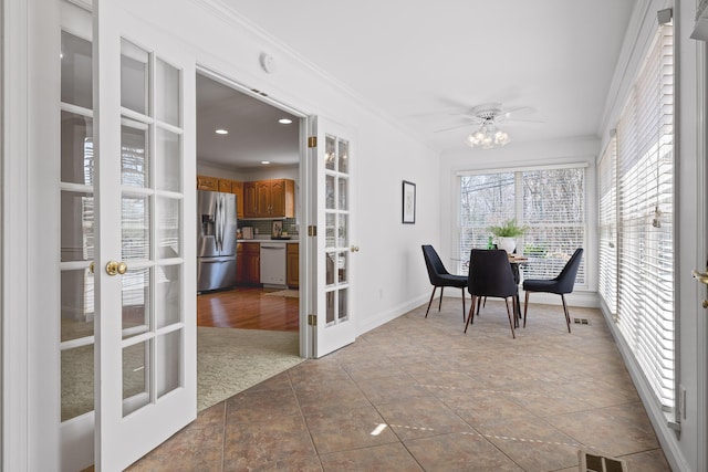 sunroom / solarium featuring french doors, visible vents, and a ceiling fan